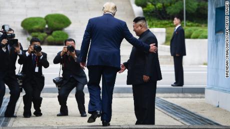 US President Donald Trump steps into the northern side of the Military Demarcation Line that divides North and South Korea as North Korea&#39;s leader Kim Jong Un looks on. 