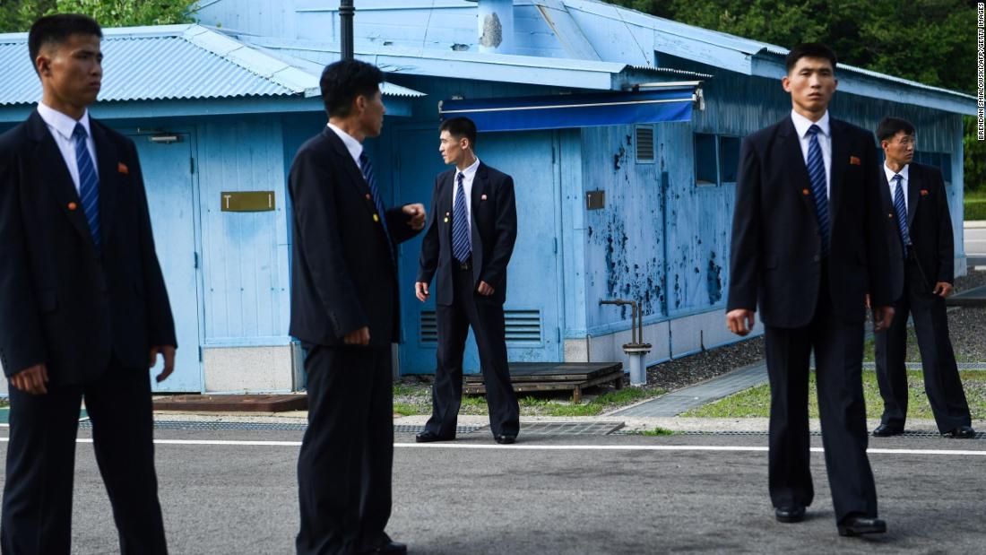 North Korean security agents keep watch south of the Military Demarcation Line that divides North and South Korea, as Trump and Kim meet in the Joint Security Area of Panmunjom in the Demilitarized zone on June 30.