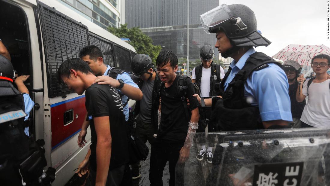 Police detain protesters near the government headquarters in Hong Kong on July 1.