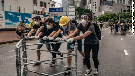 Anti-extradition protesters move barricades on a street outside the Legislative Council Complex ahead of the annual flag raising ceremony of 22nd anniversary of the city&#39;s handover from Britain to China on July 1, 2019 in Hong Kong, China. Pro-democracy demonstrators in Hong Kong have organized rallies over the past weeks, calling for the withdrawal of a controversial extradition bill, the resignation of the territory&#39;s chief executive Carrie Lam, an investigation into police brutality, and drop riot charges against peaceful protesters. (Photo by Anthony Kwan/Getty Images)