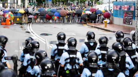 Demonstrators stand off against riot police early Monday.