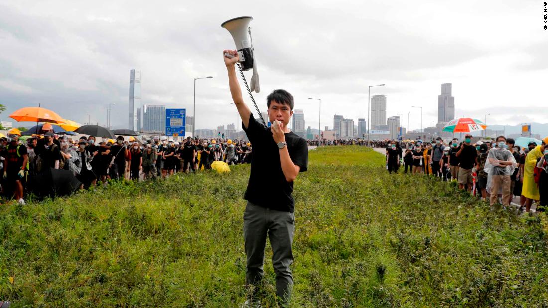 Pro-democracy lawmaker Roy Kwong rallies demonstrators with a megaphone on July 1.