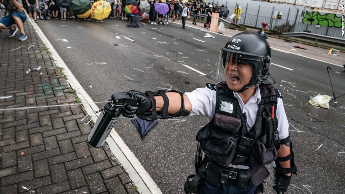 A police officer uses pepper spray during a clash with protesters on July 1.