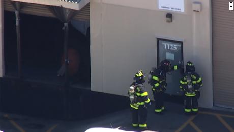 Firefighters check a Facebook mailing facility in California for the possible presence of sarin.