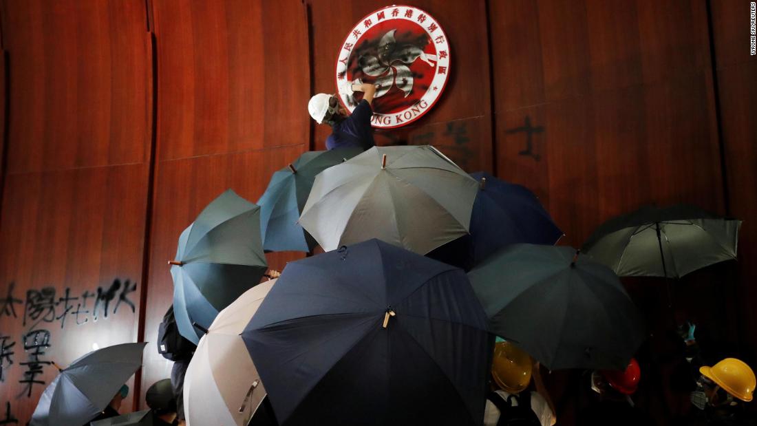 A demonstrator sprays paint inside a chamber at Hong Kong's Legislative Council building, where protesters forced their way in on Monday, July 1.