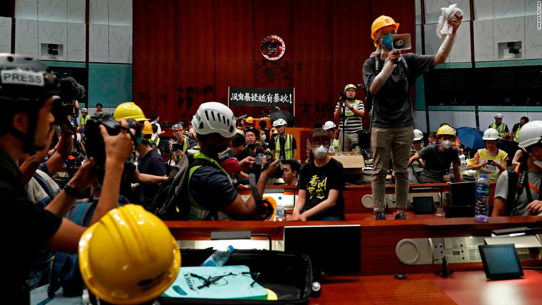 A protester uses a megaphone to speak to other protesters inside the Legislative Council building.