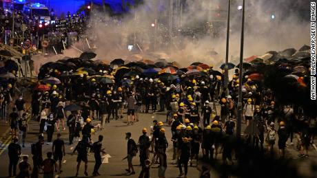 Police fire tear gas at protesters near the government headquarters in Hong Kong on July 2, 2019, on the 22nd anniversary of the city&#39;s handover from Britain to China. - Hundreds of protesters stormed Hong Kong&#39;s parliament late on July 1 as the territory marked its China handover anniversary, ransacking the building and daubing its walls with graffiti as the city plunged into unprecedented depths of political chaos. (Photo by Anthony WALLACE / AFP)        (Photo credit should read ANTHONY WALLACE/AFP/Getty Images)