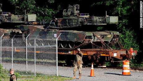 Military police walk near Abrams tanks on a flat car in a rail yard, Monday, July 1, 2019, in Washington, ahead of a Fourth of July celebration that President Donald Trump says will include military hardware. (AP Photo/Patrick Semansky)