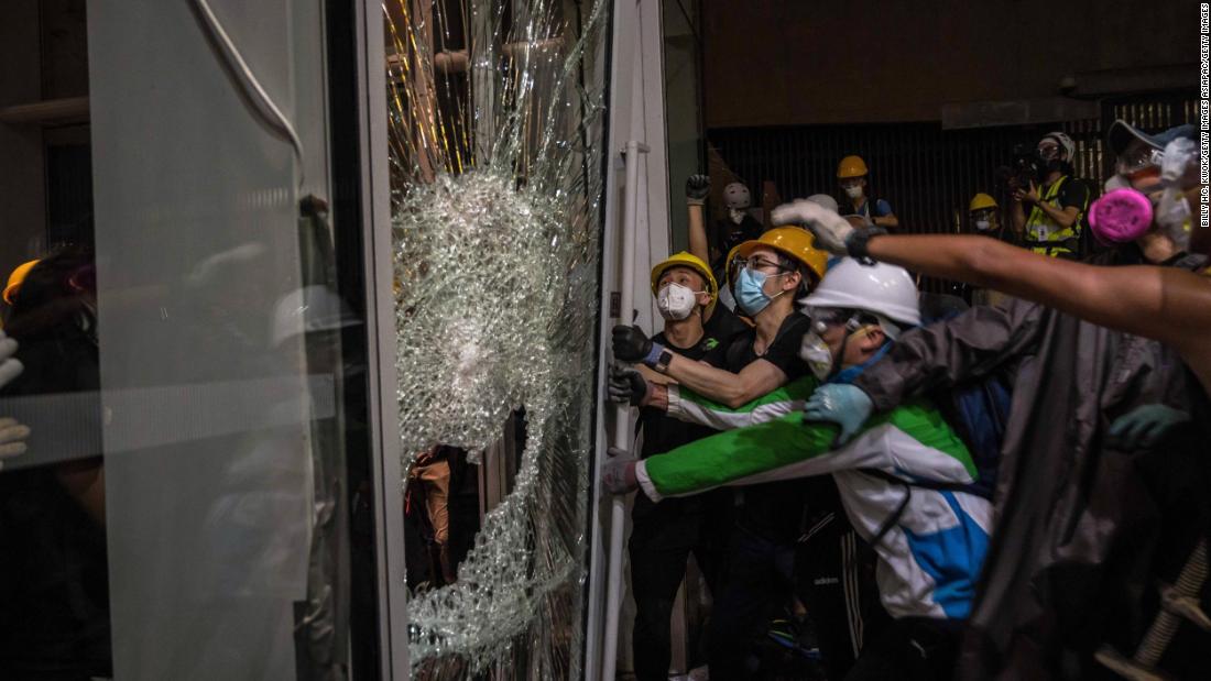 Protesters smash glass doors and windows to break into the parliament chamber of Legislative Council Complex on July 1.