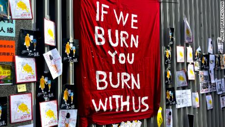 A flag reading &quot;If we burn, you burn with us,&quot; erected outside Hong Kong's legislature on July 1, 2019.