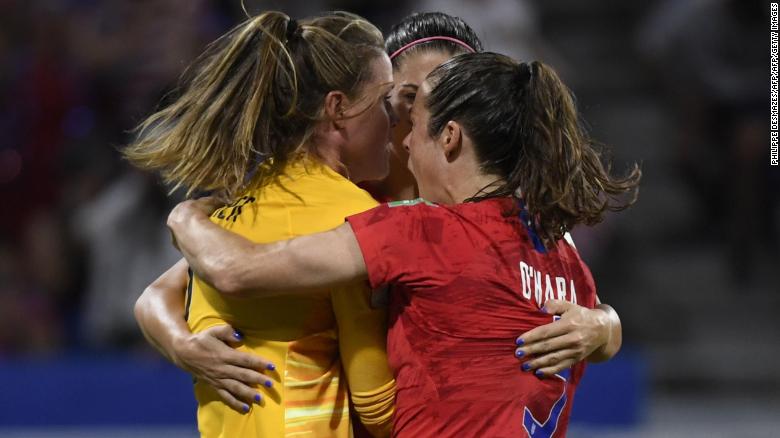 United States goalkeeper Alyssa Naeher is mobbed by teammates after her crucial penalty save.