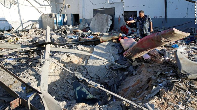 A policeman is seen at the site of an airstrike which hit a migrant detention center in the Tajoura suburb of the Libya&#39;s capital, Tripoli, on Wednesday, July 3.