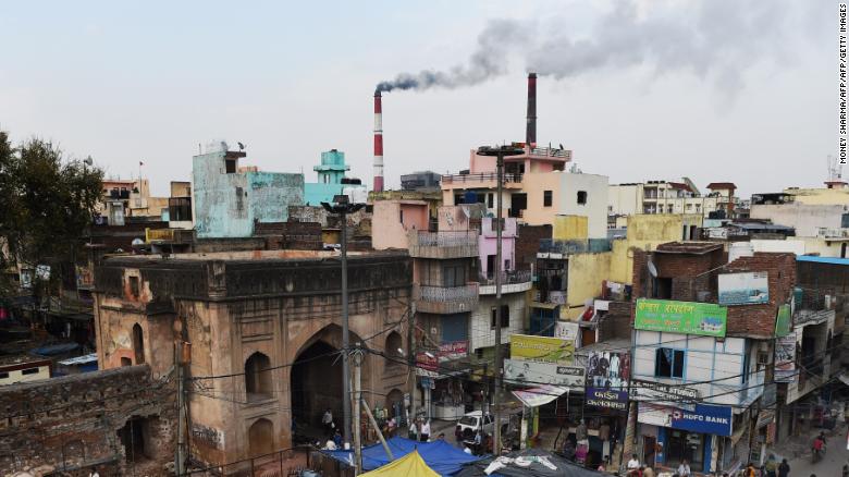 In this photograph taken on April 6, 2015, smoke billows from two smoke stacks at the coal-based Badarpur Thermal Station in New Delhi. A study by the Centre of Science and Environment in India found the plant which produces 705 MW (Megawatts) is one of the country's most polluting and inefficient power plants. Authorities insist they must focus on meeting the growing needs of its 1.25 billion people, 300 million of whom lack access to electricity. In its action plan for the Paris COP21 meet, India pledges to reduce its carbon intensity -- a measure of a country's emissions relative to its economic output -- by 35 percent by 2030, rather than an absolute cut in emissions. 
Globally, India is the third largest carbon-emitting country -- though its per capita emissions are only one third of the international average -- according to the World Resources Institute.  AFP PHOTO / MONEY SHARMA 