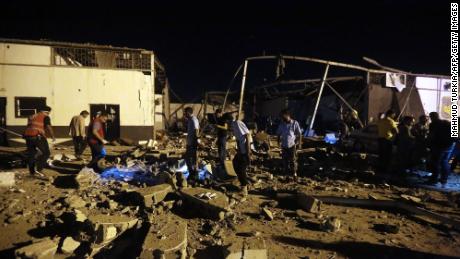 Emergency workers and other recover bodies after an airstrike killed nearly 40 at Tajoura Detention Center, east of Tripoli on early July 3.