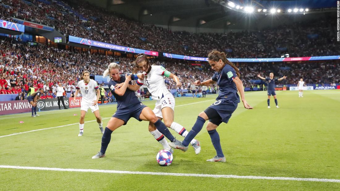 Morgan is challenged by French players Amandine Henry, left, and Amel Majri.