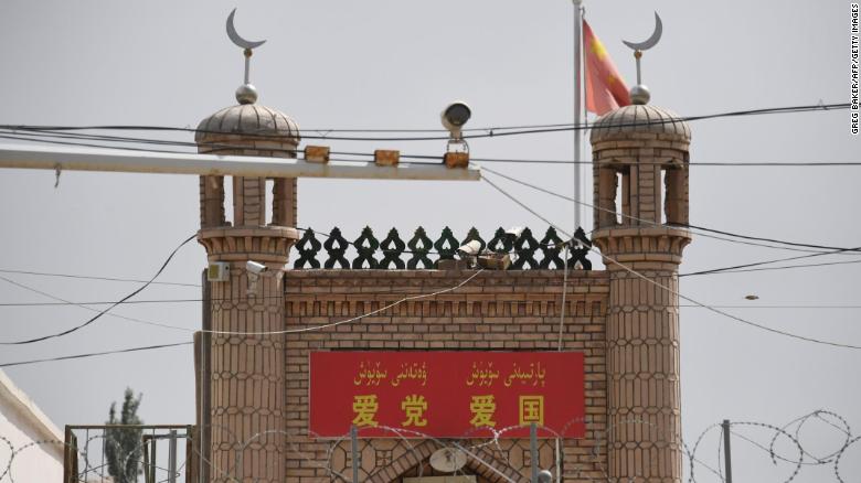 The Jieleixi No.13 village mosque in Yangisar, south of Kashgar, in China's western Xinjiang region on June 4, with a banner saying &quot;Love party, love country.&quot;
