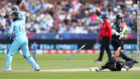 Ross Taylor of New Zealand is run out as Jos Buttler breaks the stumps after a throw from Adil Rashid.