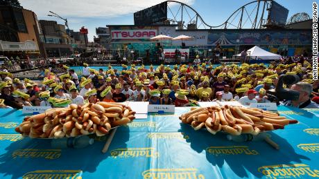 Fans wear themed foam hats as they attend the 2019 Nathan&#39;s Famous Fourth of July Hot Dog Eating Contest in Brooklyn. (Photo by Anthony Behar/Sipa USA)(Sipa via AP Images)