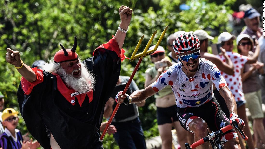 France&#39;s Julian Alaphilippe, wearing the best climber&#39;s polka dot jersey, seizes the fork of legendary Tour de France fan Didi Senft, nicknamed &quot;The Devil,&quot; during the 17th stage of last year&#39;s race. &quot;The Devil&quot; is sure ot make his customary appearances this year.