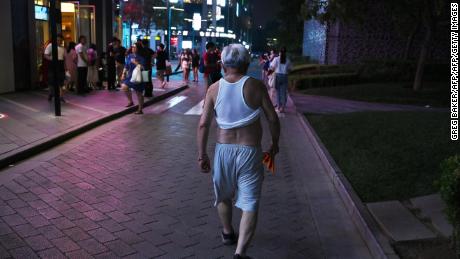 A man sports a Beijing bikini as he walks outside a shopping mall in Beijing on June 28, 2019. 