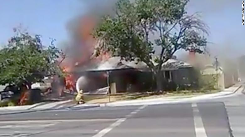 Firefighters battle a house fire in Ridgecrest, California.