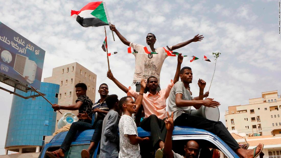 Sudanese protesters celebrate in the streets of the capital, Khartoum, after ruling generals and protest leaders announced they have reached an agreement on a new governing body Friday.