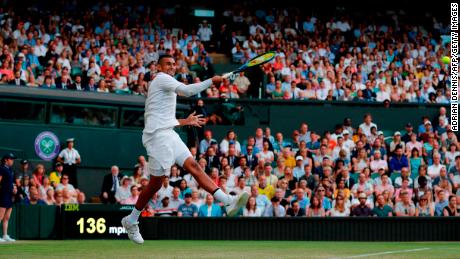 Nick Kyrgios fires a forehand against Rafael Nadal on Centre Court. 