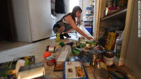 One Ridgecrest resident cleans up her kitchen after a magnitude 7.1 earthquake dumped food items on the floor at her mobile on July 6, 2019. 