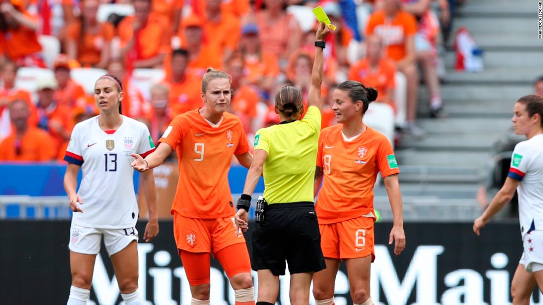 Referee Stephanie Frappart shows an early yellow card.