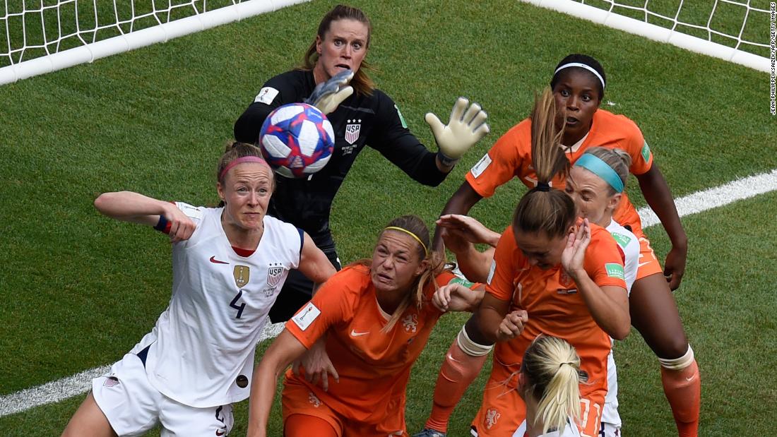 Players eye a ball in the US penalty box.