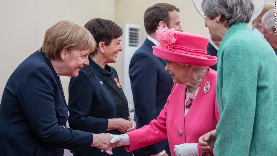 Britain's Queen Elizabeth II, accompanied by Prime Minister Theresa May, greets Merkel in Portsmouth, England, in June 2019. It was ahead of an event marking the 75th anniversary of the D-Day invasion.