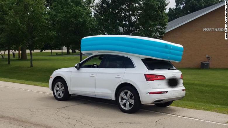 Police said the mom was trying to keep the pool from flying away as she drove.