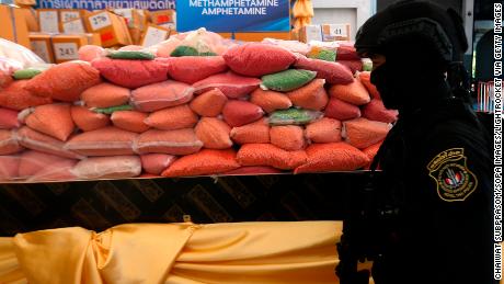 A police officer from Thailand&#39;s Narcotics Control Board stands guard in front of bags of methamphetamine pills in Ayutthaya province, north of Bangkok.