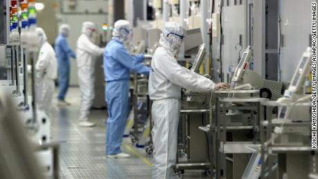 Technicians at work in the clean room of the Fab Equipment at a semiconductor company, Renesas Technology Corp. in Ibaraki, Japan.