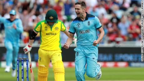 Chris Woakes of England celebrates taking the wicket of David Warner.