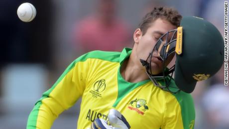 Australia&#39;s Alex Carey reacts after being hit by a bouncer from England&#39;s Jofra Archer.