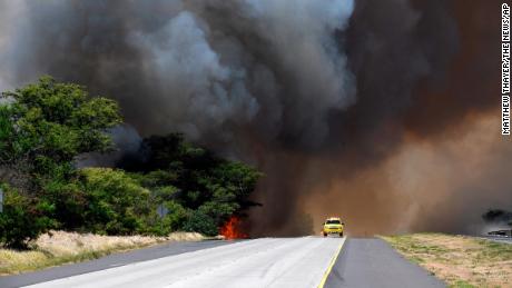 A plume of smoke from a brush fire closes Kuihelani Highway in Central Maui, Hawaii, Thursday, July 11, 2019. Hawaii emergency officials ordered an evacuation on Maui due to the runaway brush fire. (Matthew Thayer/The News via AP)