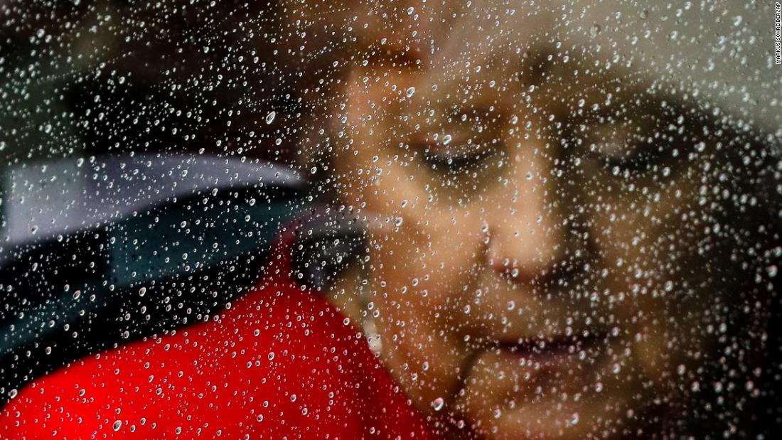 Raindrops cover the window of a car as Merkel arrives for the opening of the James-Simon-Galerie in Berlin in July 2019.