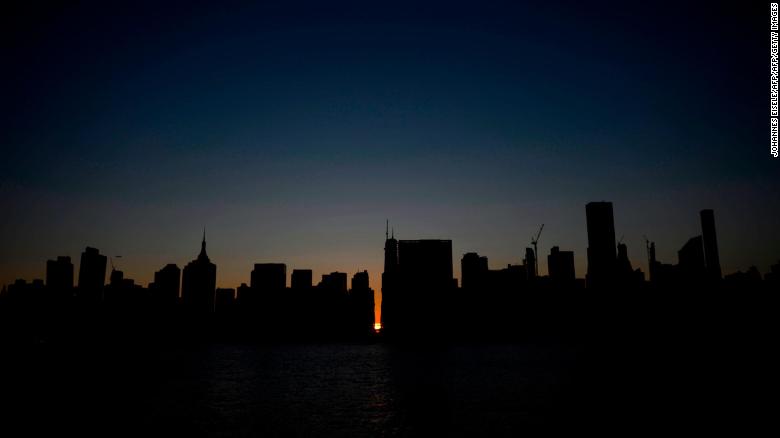 The sun sets behind 42nd Street in Manhattan during the power outage. 