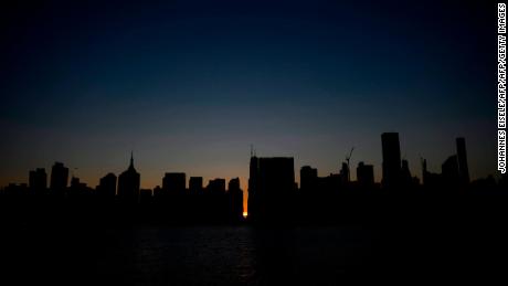 The sun sets behind 42nd Street in Manhattan during a power outage on Saturday. 