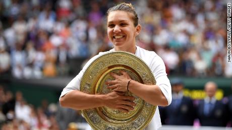 Simona Halep of Romania poses for a photo with the trophy after winning the Ladies&#39; Singles final against Serena Williams of The United States during Day twelve of The Championships - Wimbledon 2019 at All England Lawn Tennis and Croquet Club on July 13, 2019, in London, England.