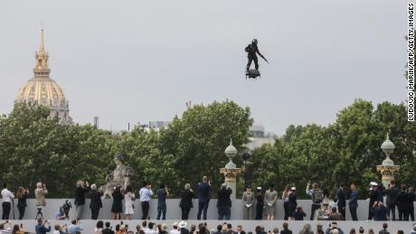 TOPSHOT - Zapata CEO Franky Zapata flies a jet-powered hoverboard or &quot;Flyboard&quot; prior to the Bastille Day military parade down the Champs-Elysees avenue in Paris on July 14, 2019. (Photo by ludovic MARIN / AFP)        (Photo credit should read LUDOVIC MARIN/AFP/Getty Images)