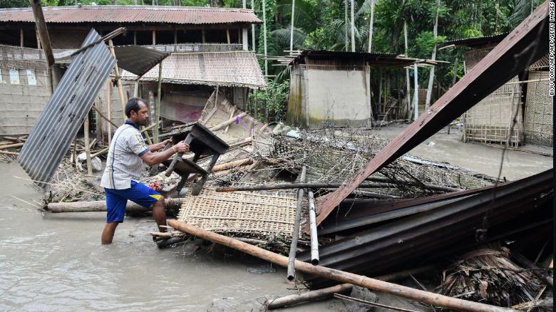 An Indian woman near the debris of her house in the state of Assam, on July 13, 2019.