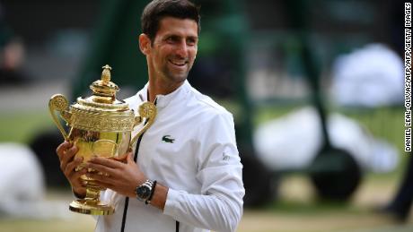 Serbia&#39;s Novak Djokovic holds the winner&#39;s trophy during the presentation after beating Switzerland&#39;s Roger Federer during their men&#39;s singles final on day thirteen of the 2019 Wimbledon Championships at The All England Lawn Tennis Club in Wimbledon, southwest London, on July 14, 2019. (Photo by Daniel LEAL-OLIVAS / AFP) / RESTRICTED TO EDITORIAL USE        (Photo credit should read DANIEL LEAL-OLIVAS/AFP/Getty Images)