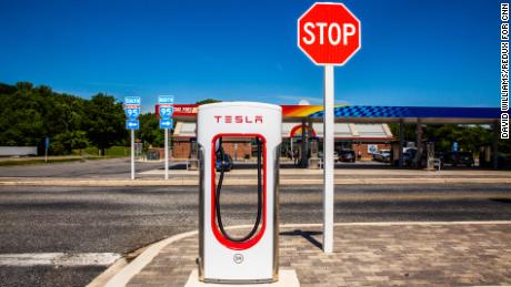 A Tesla Supercharger across the street from a gas station off Interstate-95 in Newark, Delaware.