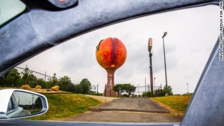 Peachoid, a 135 foot-tall water tower in Gaffney, South Carolina, painted to look like a peach, is seen through the Tesla&#39;s window.