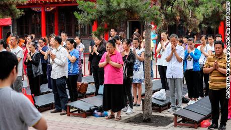 Parents pray for high marks for their children who take the National College Entrance Examination (aka Gaokao) at Ci&#39;en temple on June 7, 2018 in Shenyang.