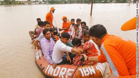 Indian officials carry out evacuations in flooded Golghat, in India&#39;s northeastern Assam state.