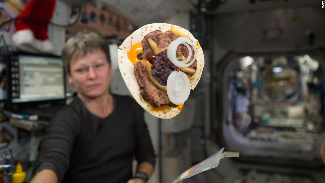 Astronaut Peggy Whitson and her cheeseburger wrapped in a tortilla are shown on the International Space Station. Since the mid &#39;80s, flour tortillas have been a staple bread item in space that provides an almost crumble-free solution.