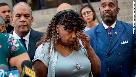 Eric Garner&#39;s mother Gwen Carr wiped away tears after speaking to reporters outside the US Attorney&#39;s office on Tuesday.
